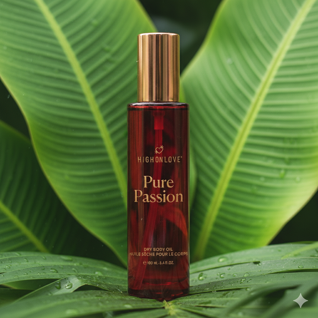 Red bottle of High on Love Pure Passion dry body oil on green leaves