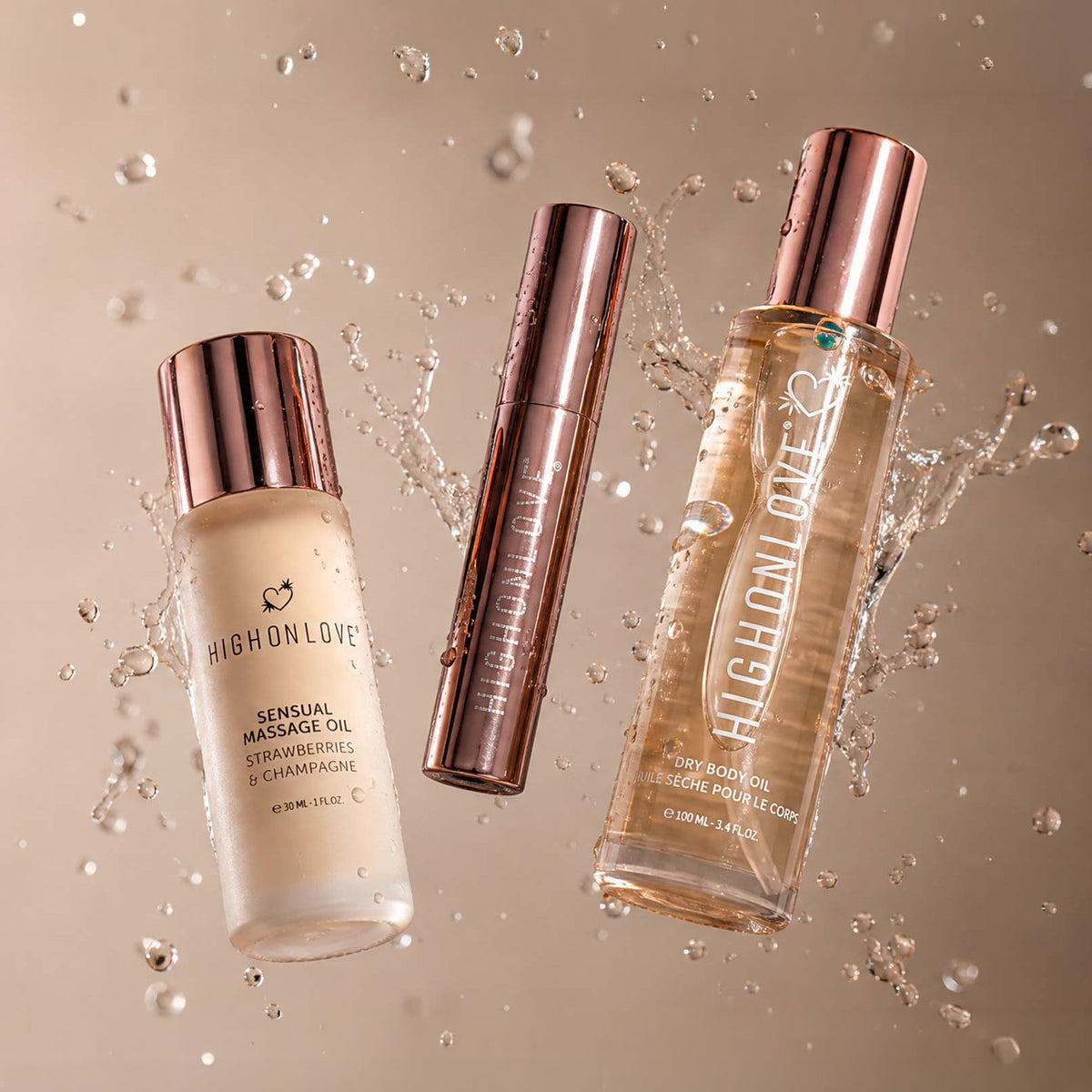 Three HighonLove skincare products floating in a water-splash studio setup: a frosted bottle of sensual massage oil, a slim tube of massage oil, and a clear bottle of hyaluronic serum with rose-gold cap, all on a warm beige background.